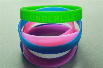 rubber bracelets in green, blue, pink laser engraved by a Thunder laser cutter canada