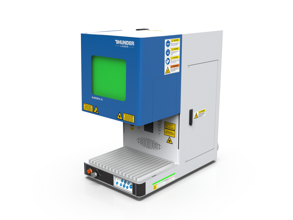 a photo of the new improved version of the Aurora laser marking machine by Thunder laser. It is a small upright machine that can sit on a table top. It has a blue box lid that slides up and down and the window in the lid is green. The machine itself is white