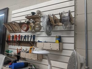 photo of boxes and hangers for tools hung on a slat wall-made on a Thunder Laser laser cutter machine