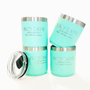 teal short wine tumbler with metal rim. Engraving reads "Hazy days: High Life wellness resort"