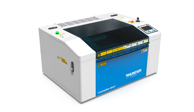 a Thunder Bolt laser cutter machine. blue and white desktop metal machine turned to the left