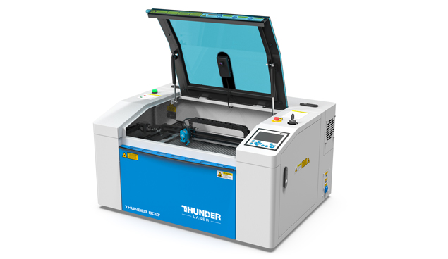 a Thunder Bolt laser cutter machine. blue and white desktop metal machine with the lid open.