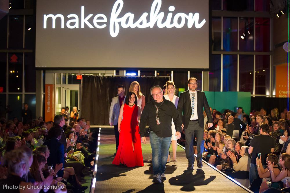 group photo of Make Fashion organizers and models on the runway