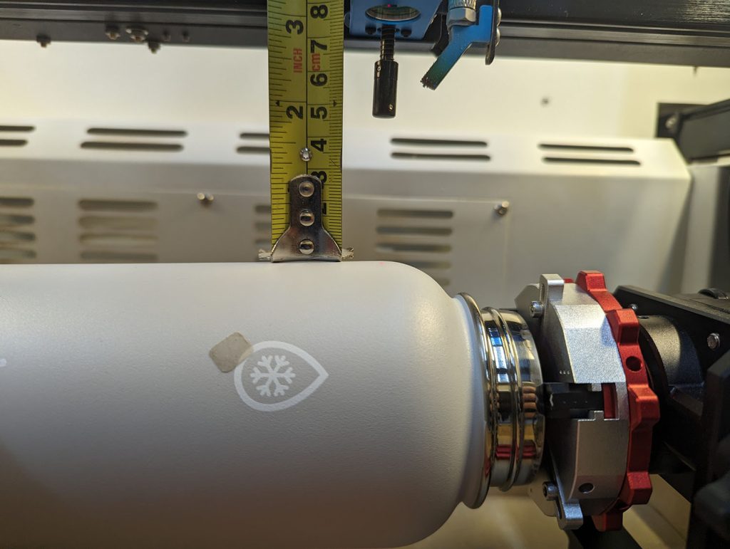 closeup image of the piburn rotary for thunderbolt and a measuring tape showing the height available above the bottle once mounted 3"