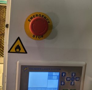 emergency stop button on a thunder laser. A red button on the top of the machine above the control pad