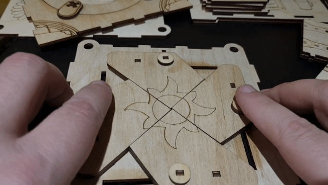 close up of a person opening and closing the iris mechanism on a wooden 3d laser cut jewelry box made by Austin Hager