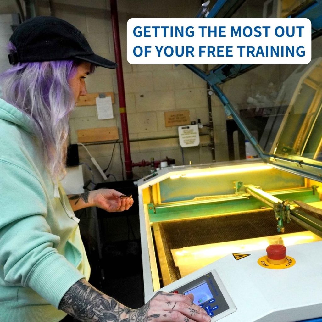 Light skinned woman with purple hair, tattoos on her arms and a mint green hoodie stands in front of a Thunder Laser Nova machine