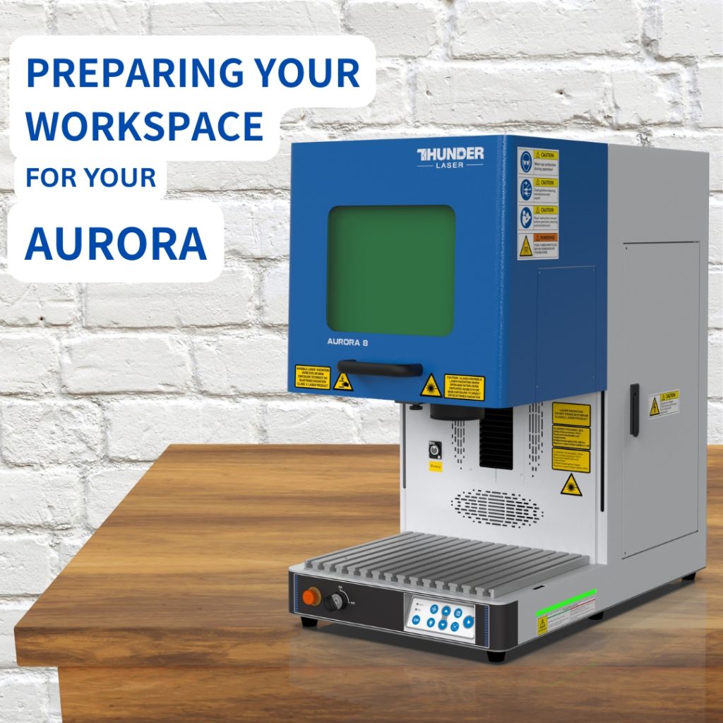 Aurora Thunder Laser fiber laser machine on a wood table top with white bricks